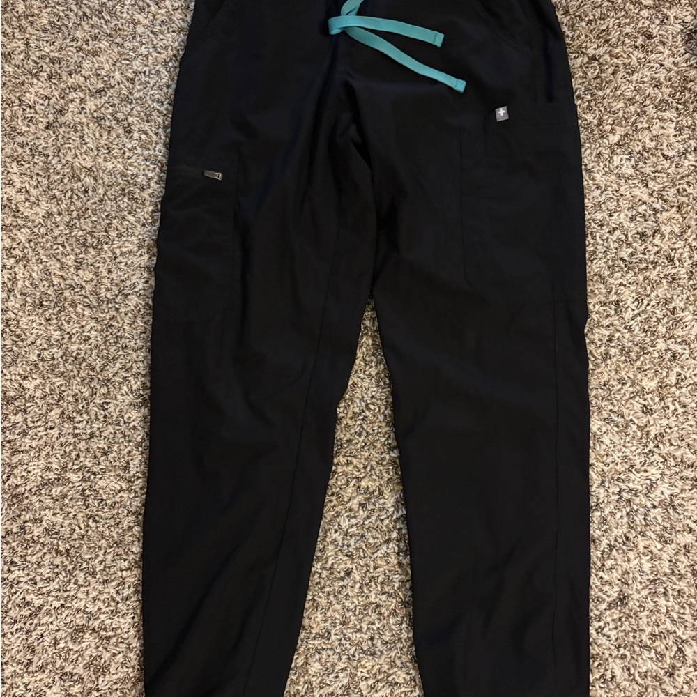 4 pairs of black scrub pants and 3 tops